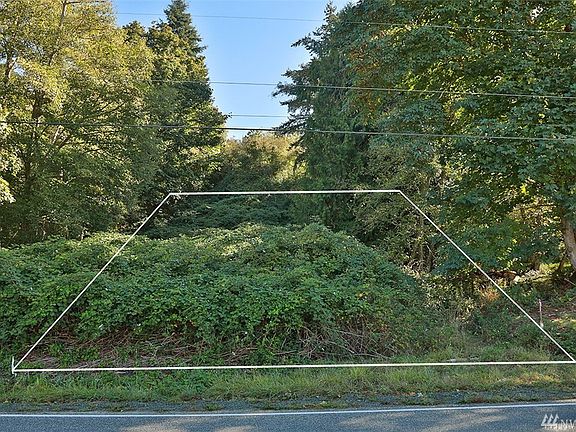The lot is sloped with increased elevation toward the back of the lot...potential for some view corridors of Puget Sound and the Olympics.