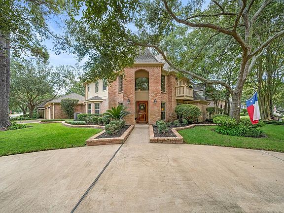 Beautiful mature trees with stone walkway leading to the front door; a gorgeous landscape brick border in the front and extended to both sides of the home.