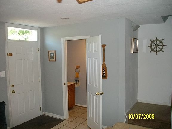 main entrance with stairway, and 1/2 bath. Living room ahead