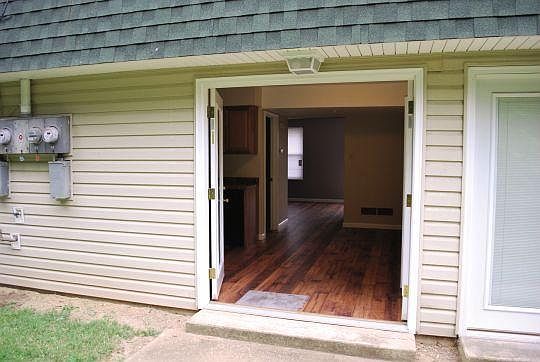Kitchen showing french doors open from outside view.