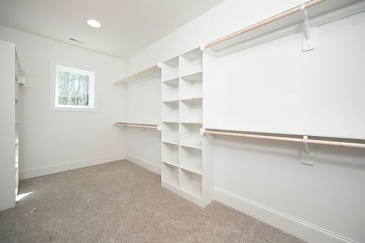Large walk in primary closet with built ins