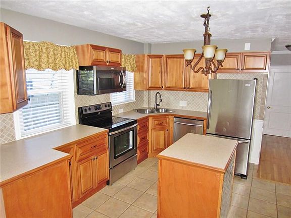 Gorgeous Updated Kitchen with Stainless Steel Appliances, Center Island, Ceramic Tile Floors and Plenty of Counter and Storage S