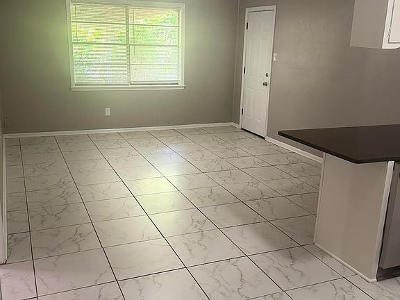 View of dining area in kitchen with back door that leads to the laundry room.