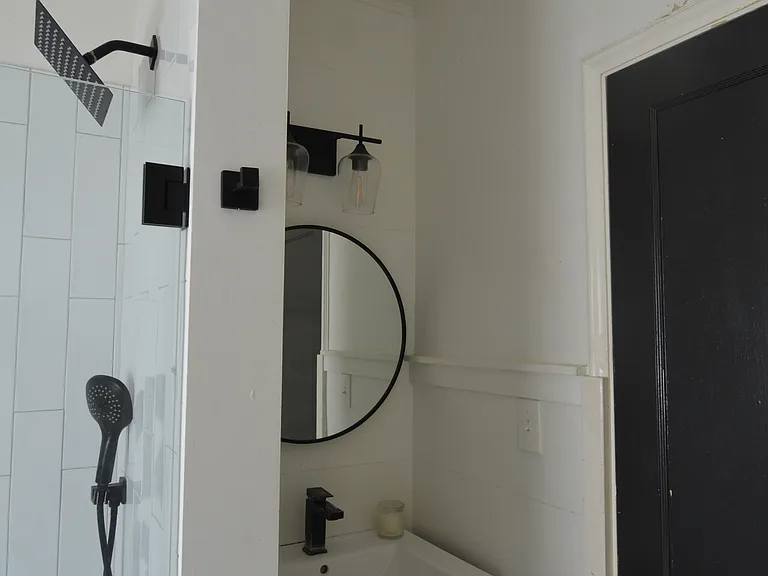 Modern vanity and shower upstairs.