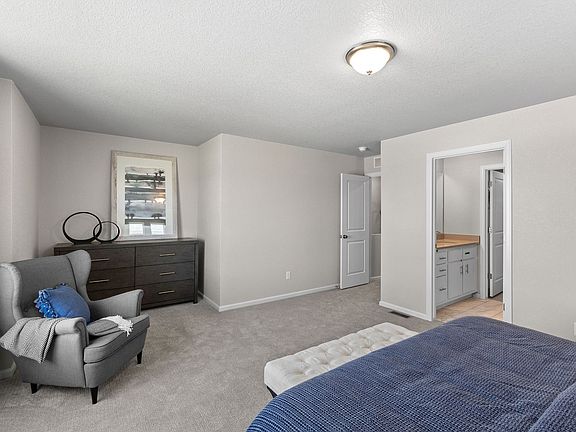 A view of the entrance to the hallway and primary bathroom