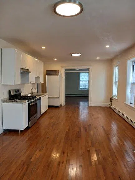 The open plan consists of a light-filled combination living and dining room with an all new kitchen with new appliances including a dishwasher.