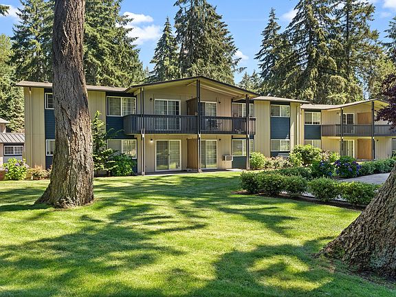 Experience serene living with this spacious, light-filled apartment set amidst picturesque forest views.