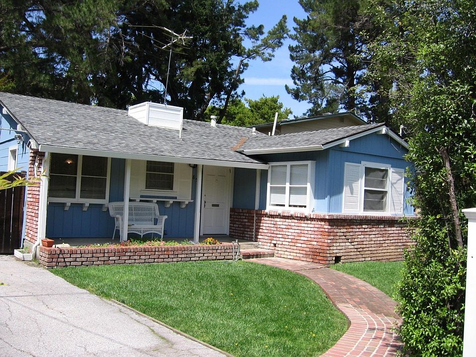 Front view of home through a gate that can close for extra p