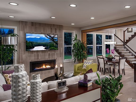 Family Room with fireplace with access to covered deck. Photo not of actual home - may contain optional features.