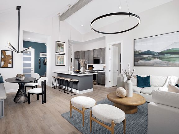 The living room features vaulted ceilings that create an open, airy feel and is conveniently located