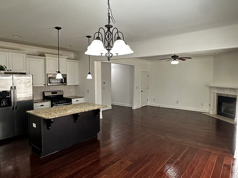 Full kitchen with appliances, gas stove, dishwasher, above stove microwave, double door fridge.