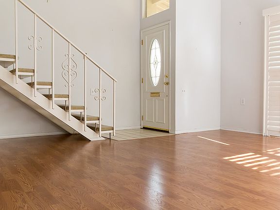 LR view to stairs, front doo