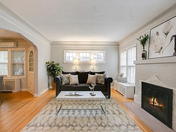 Living Room: Includes wood burning fireplace & deep coat closet w/ Elfa Shelving (#1 only). Bonus rod in far back of closet for out of season coats/clothes and/or hanging shoe storage.