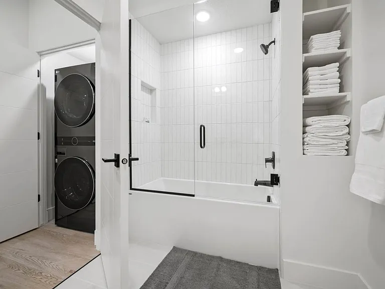 Full bath with tub and shower 
Closet with stacked washer and dryer unit