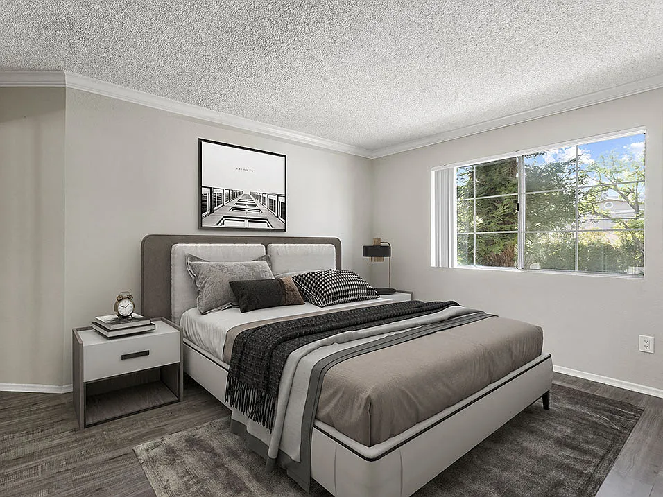Carpeted bedroom with large window for natural light.