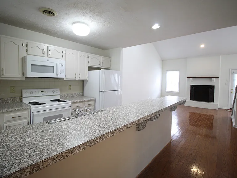 Pantry, coat closet and half bath located across from Kitchen. Breakfast bar