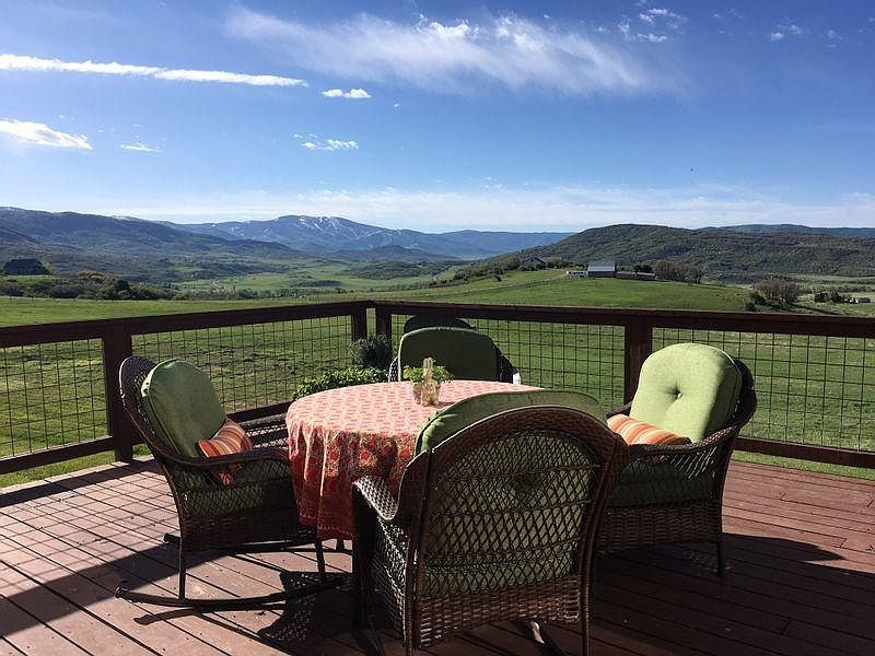 old photo of deck with furniture. Deck is currently unfurnished