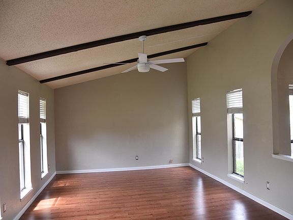 Enter Living Room with high ceiling, laminate flooring and 5 Windows!