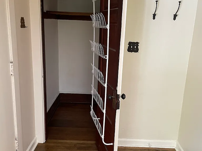 Entry with closet and shoe rack.