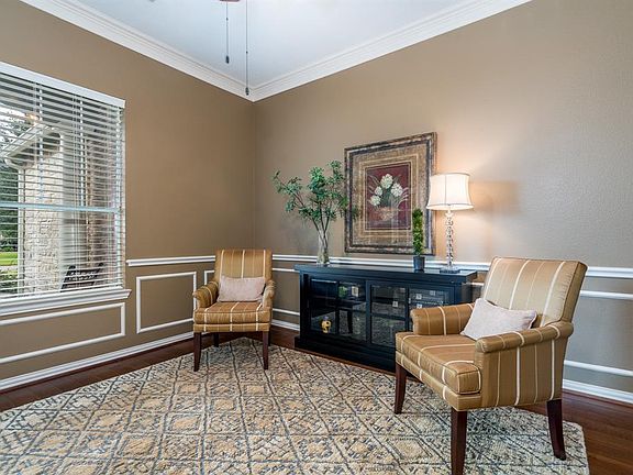 Just off the foyer and behind double French doors you will find a private study with views of the porch and beyond! This spaces features gorgeous hardwood flooring, chair, crown and box molding that add that extra touch!