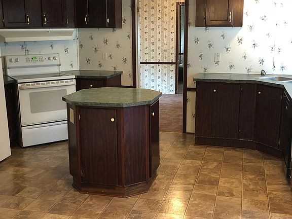 Kitchen is lavish. Note smooth top stove. Utility room is