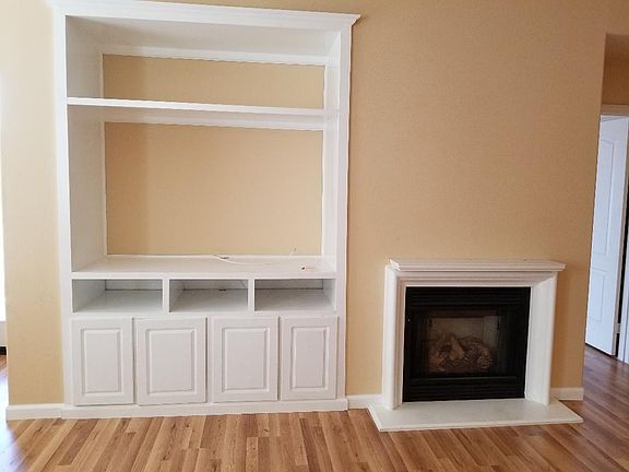 Entertainment hutch large enough for 65 inch TV. Electric fireplace with mantle.