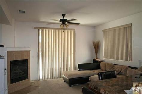 Living room with cozy fireplace & slider to back yard.