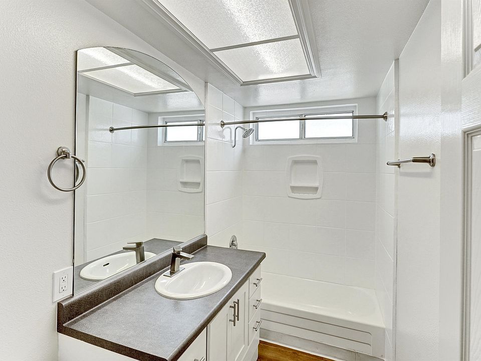 A bathroom with a sink vanity and a mirror above it.