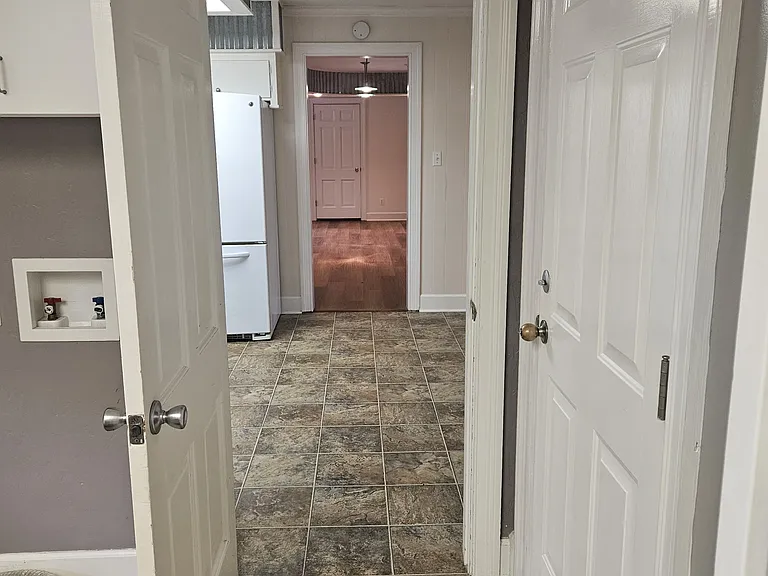 View from laundry to the kitchen, to the living room.