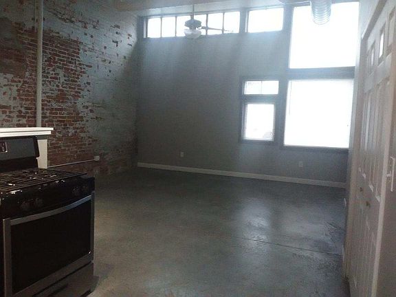 Large living room with polished concrete flooring.