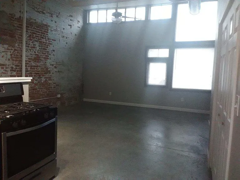 Large living room with polished concrete flooring.