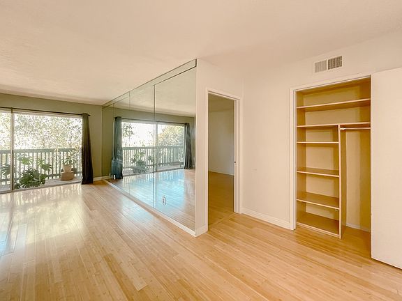 Living room with storage space, entrance to the master bedroom