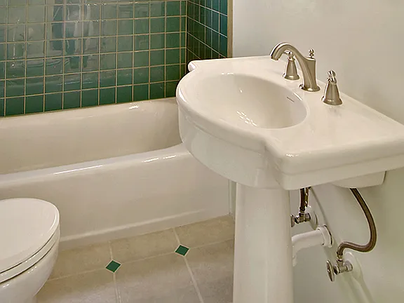 Close up of glass tiles and decorative tile floor in bathroom