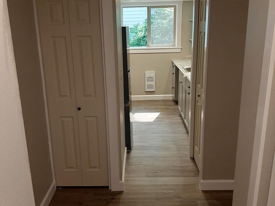 From the front door, looking into the kitchen. Look at those beautiful new floors, luxury vinyl plank that is quiet, soft underfoot, and insulating!