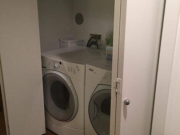 Laundry in hallway leading to first floor bedroom. Washer a