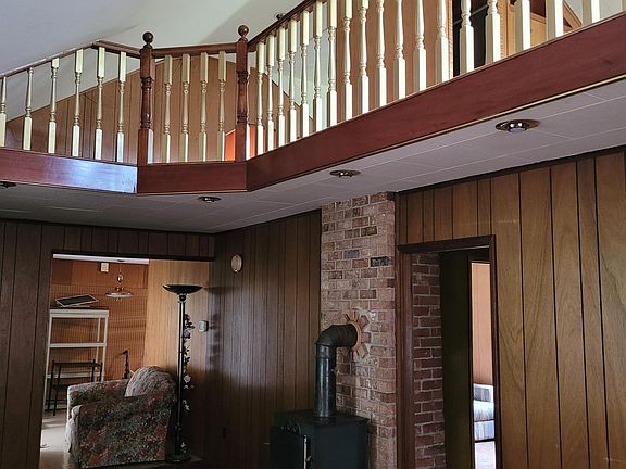 This is the most beautiful loft balcony you will ever see! Carved wood banisters with gold and diamond looking accents! Suttle shimmering look and part of the furnishing of the home is a halogen lamp and if you put a 500 bulb in it, it really makes it s