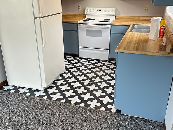 Kitchen with fresh paint and flooring.