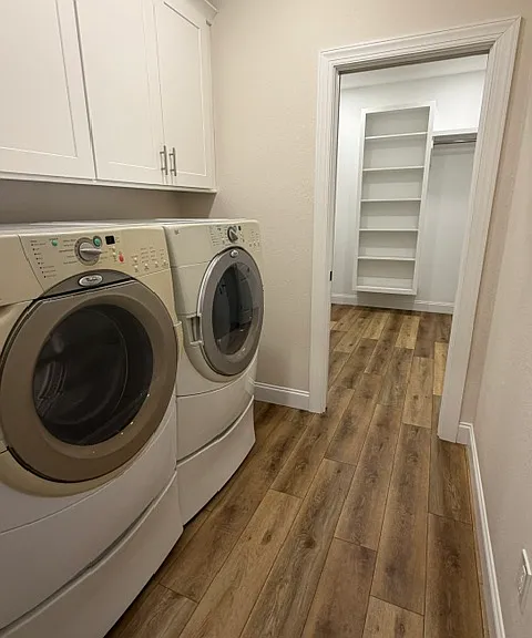 Separate laundry room between mudroom and primary walk-in closet, comes with washer and dryer