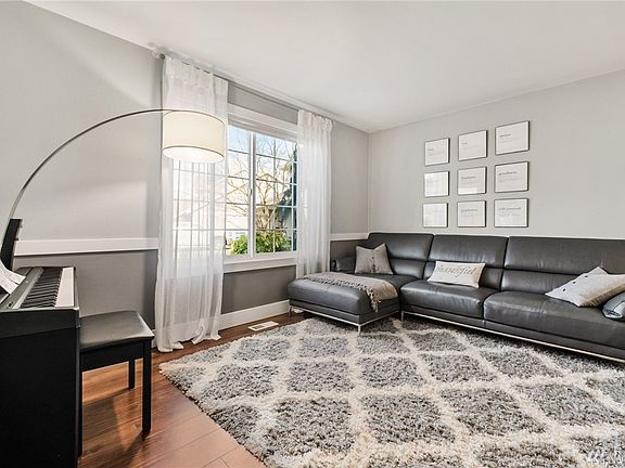 The luminous living room sits just off the front foyer. 