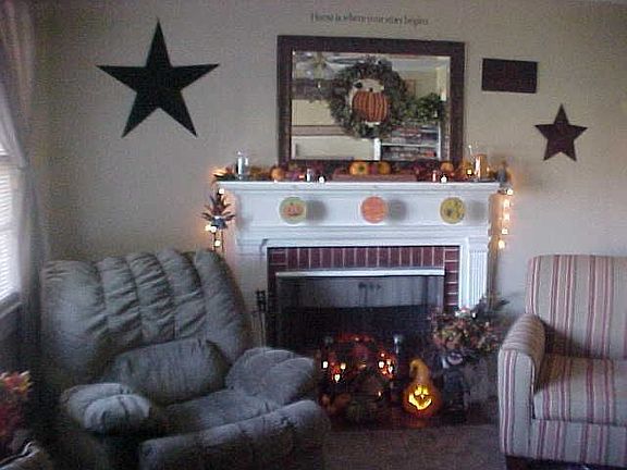 Great room has good wall space and a fireplace.