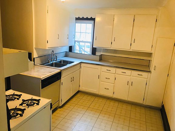 Kitchen with sitting area and equipped with dishwahser, large fridge and gas cooker