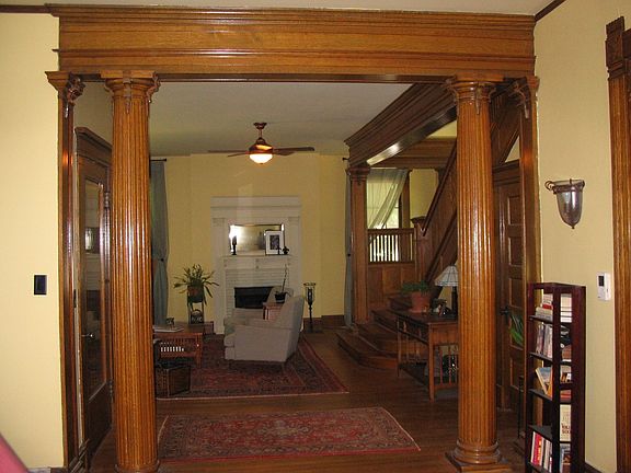 Columns between living/sitting rooms - front entry on left - stairs on right