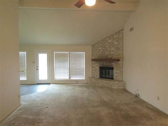 Living area with corner fireplace.