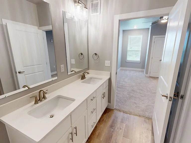 Sling Station's primary en suite bathroom features a double sink with ample storage. Sling Station's primary en suite bathroom features a double sink with ample storage.
