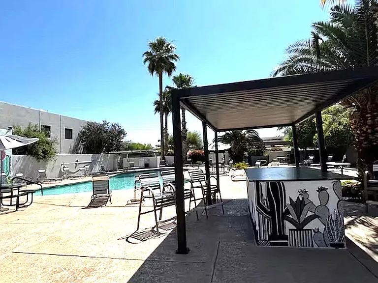 Pergola shade area with bar counter by the pool