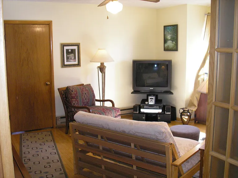 Bright, cheery living room space with new ceiling fan for cooling down or evening out the heat in winter.