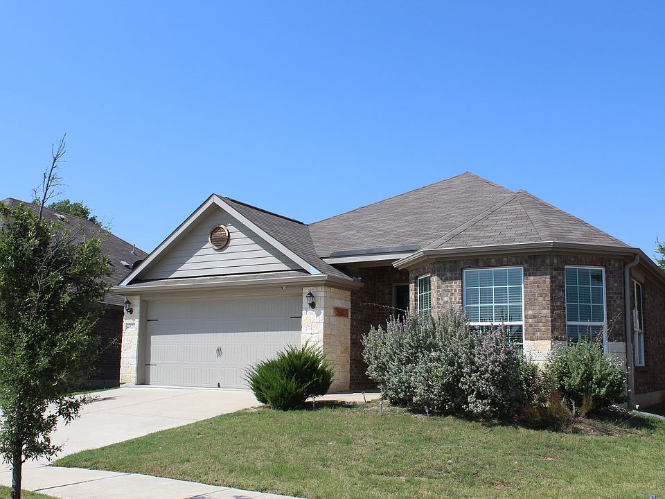 Stunning Denton house with concrete driveway, brick siding, and an attached garage!