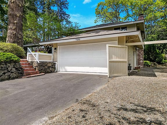 Spacious 2 car garage with room for storage and additional driveway parking.>