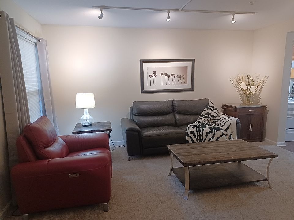 Large living room with reclining sofa and club chair. Plus carpet