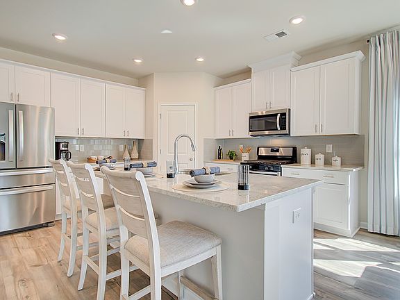 The spacious kitchen island overlooks the dining area and great room.